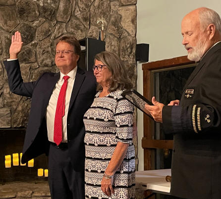 V/C David Allen swears in Cdr John Klein, who is accompanied by Anna Klein